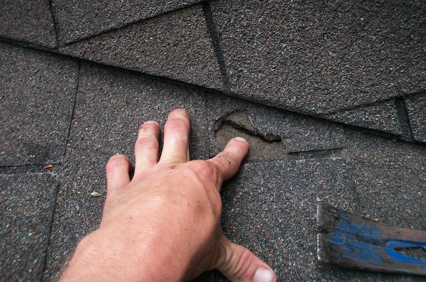 Close-up photo of asphalt shingle roof repair