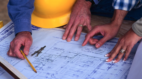 Production manager reviewing plans with client