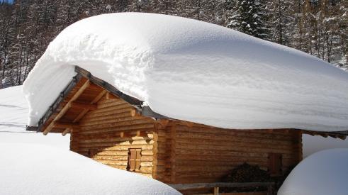The snow on this roof is several feet deep, but how much snow is too much for a roof and threatens roof collapse? 